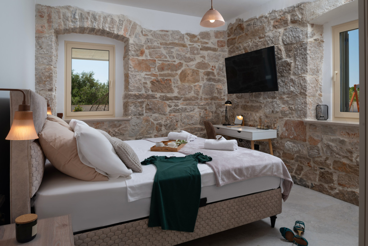 View of a luxurious bedroom at Villa Utopia with king-size bed