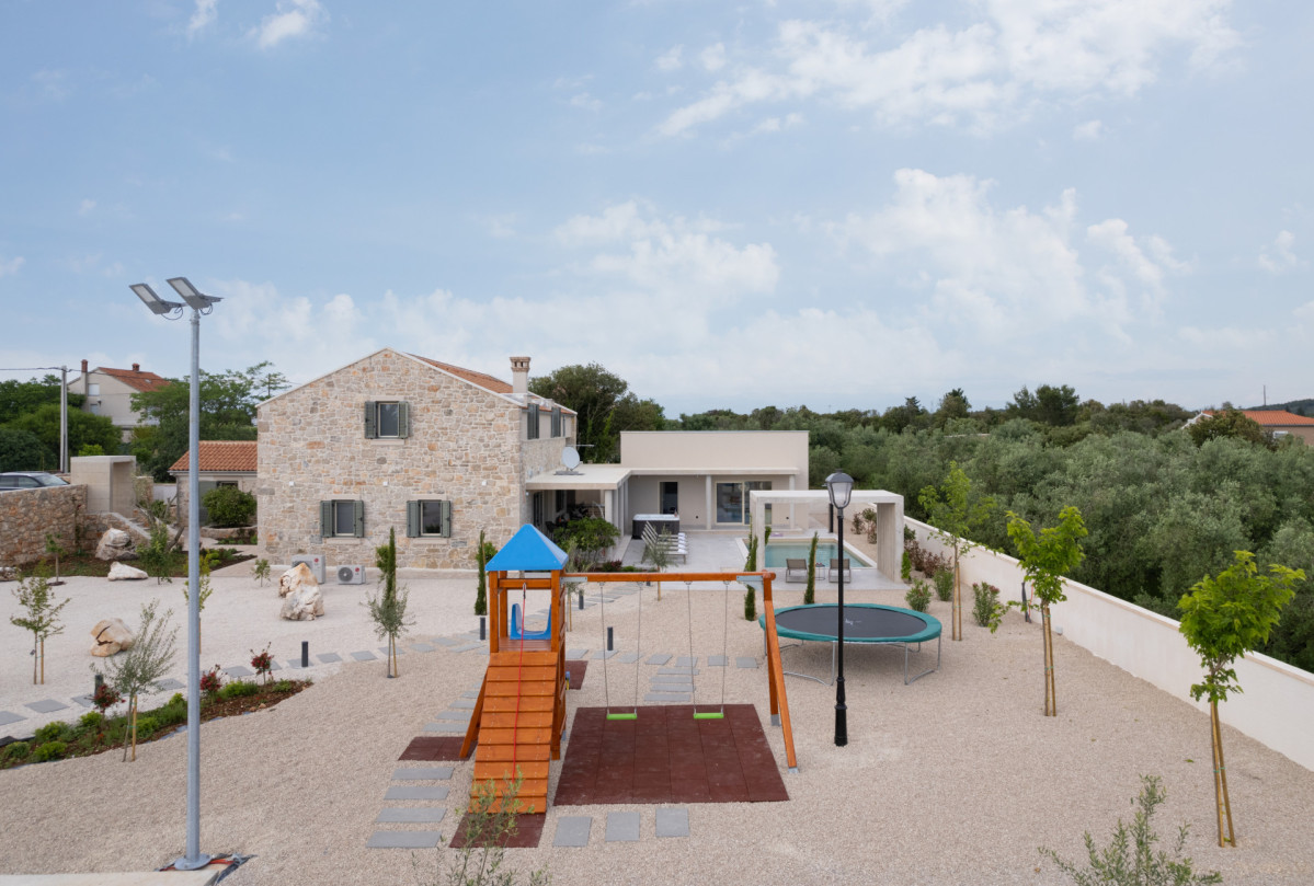 Modern Mediterranean Estate Featuring Traditional Stonework and Outdoor Play Area