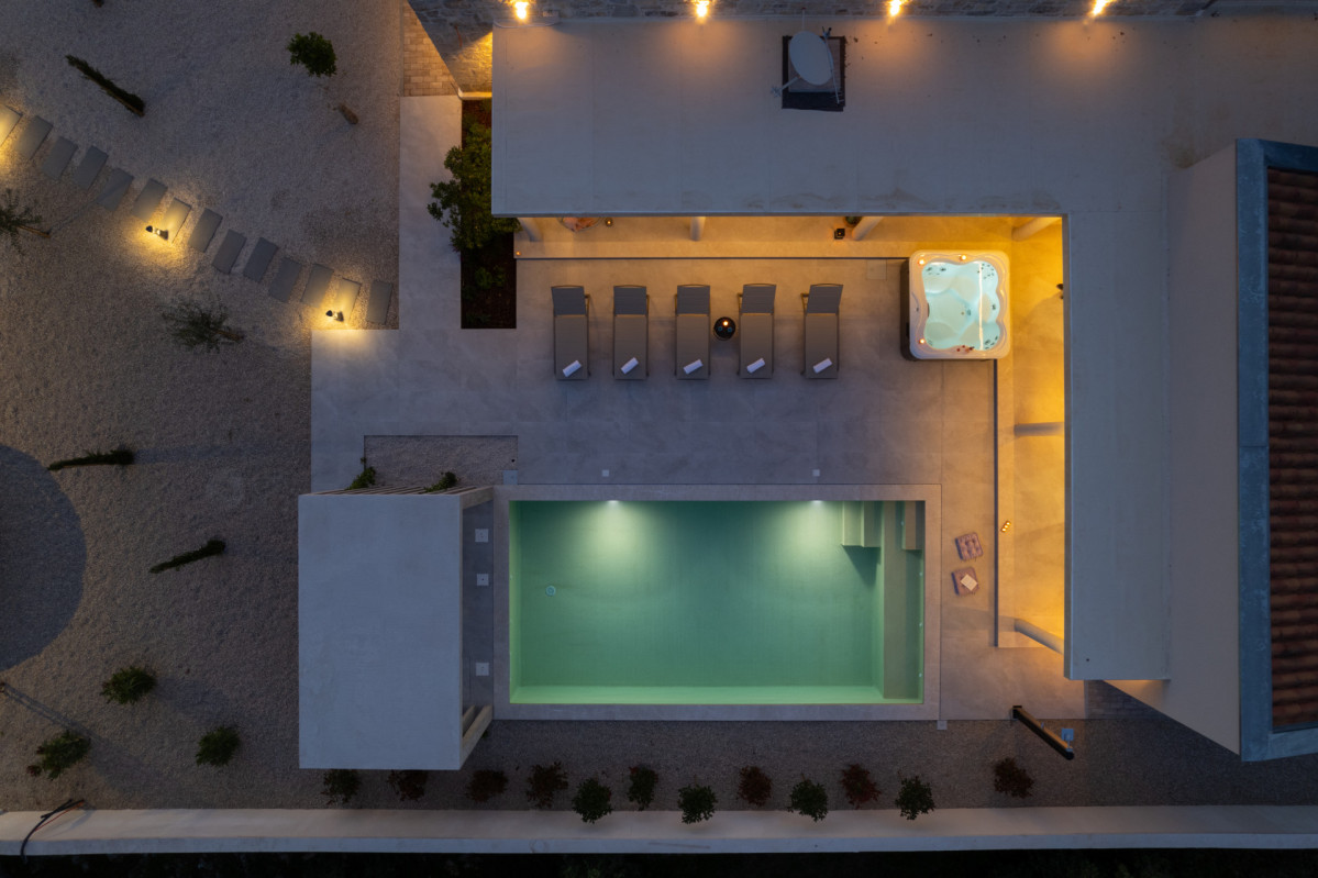Villa Utopia’s illuminated pool and spa terrace from above.
