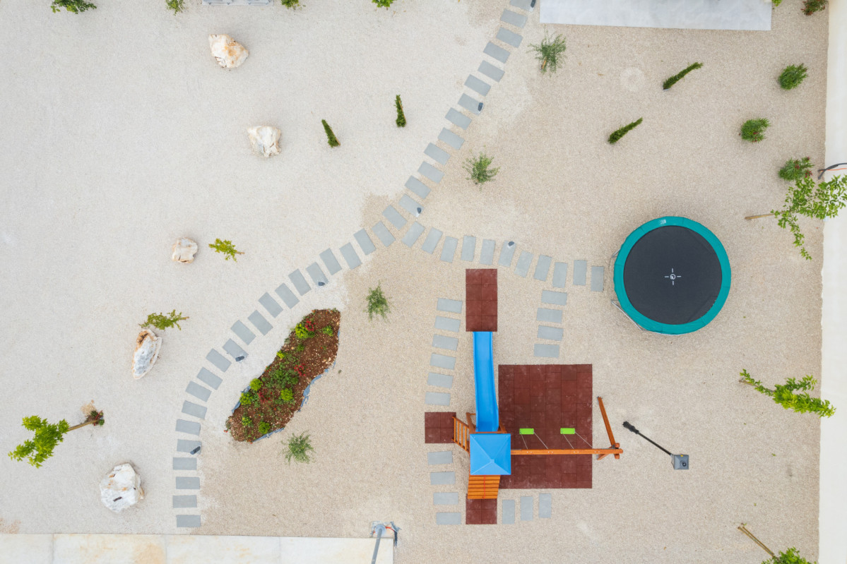 Aerial View of a Modern Backyard Playground and Trampoline