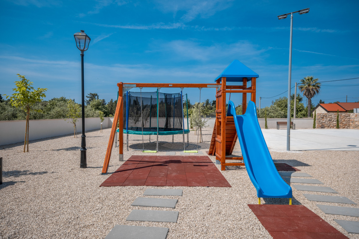 Outdoor Children's Playground with Blue Slide and Trampoline