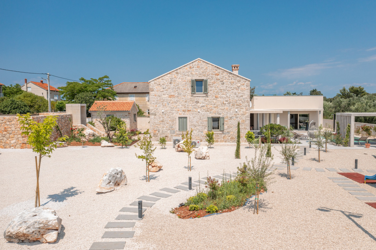 Stone facade and landscaped garden at Villa Utopia