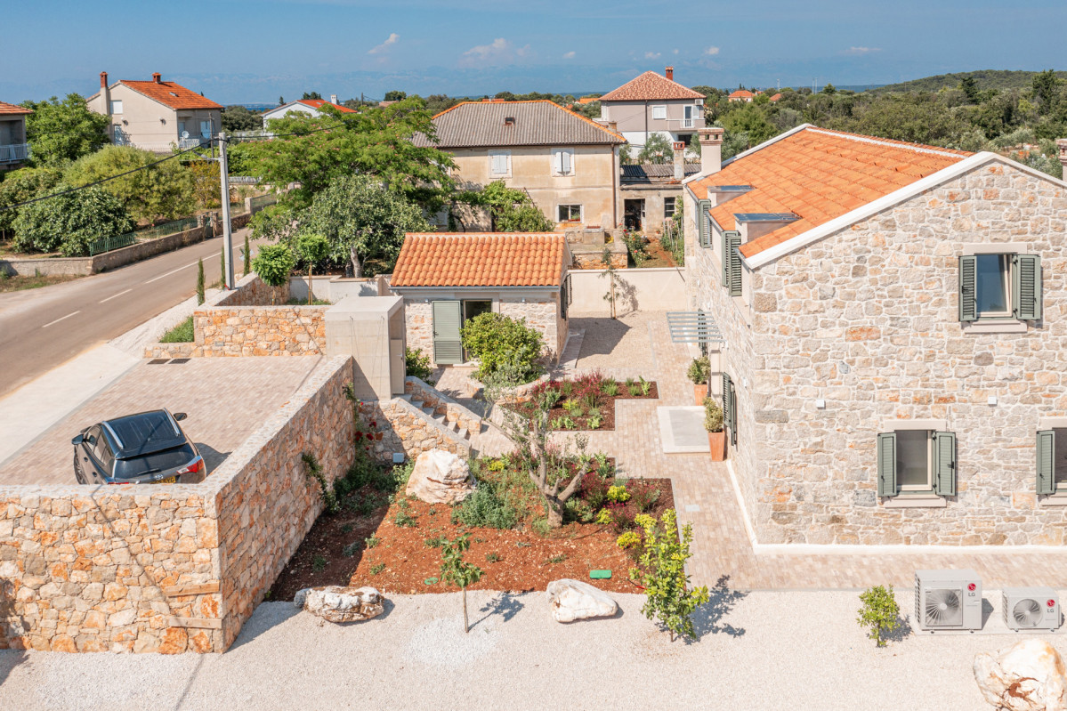 Villa Utopia on Ugljan featuring an authentic stone house with a private gravel courtyard with garden, and gated stone parking area.