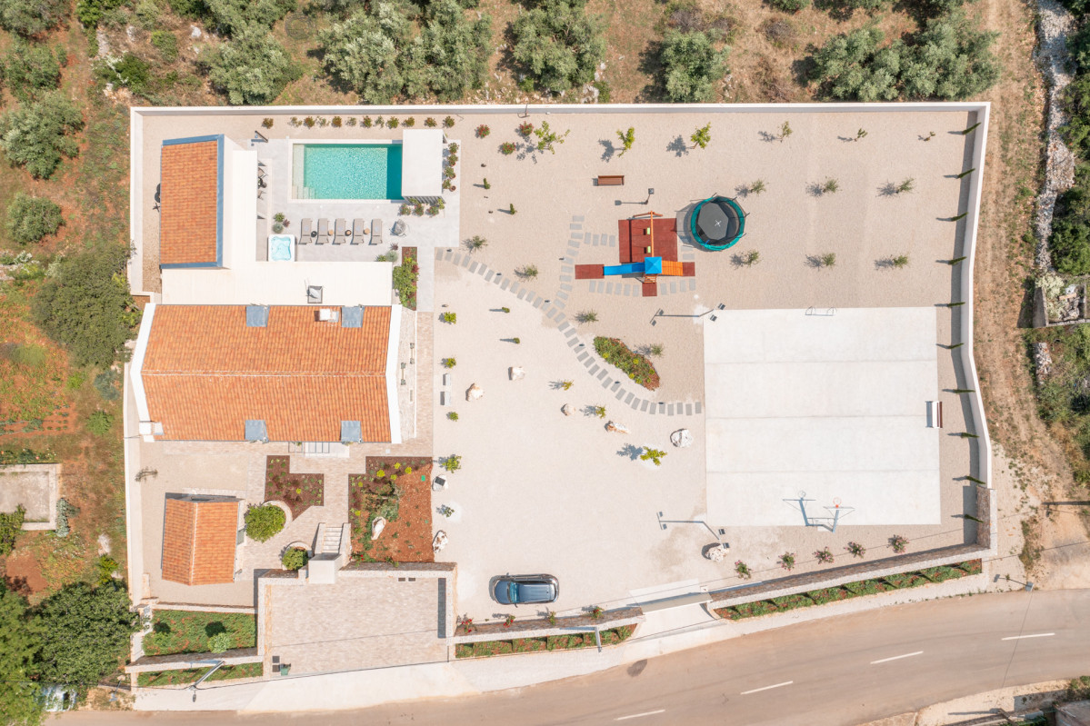 Villa Utopia overhead view with pool and court