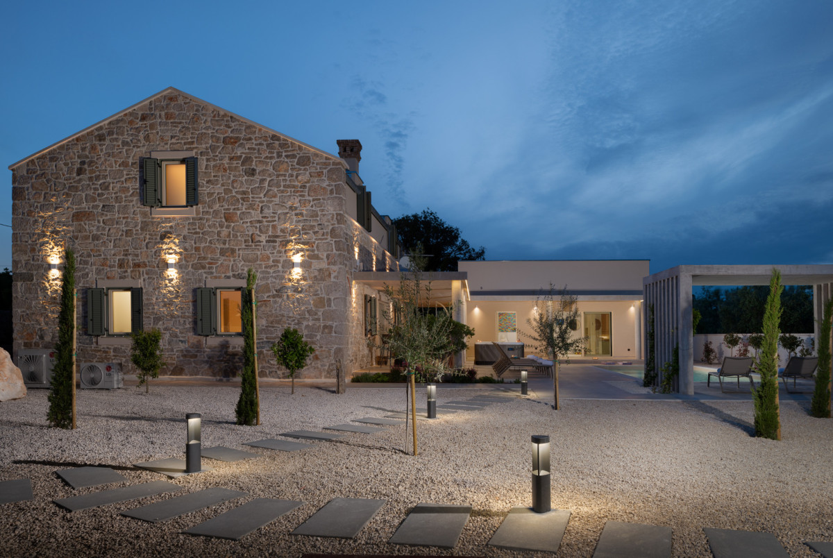 Villa Utopia: An elegant evening glow illuminates the stone facade