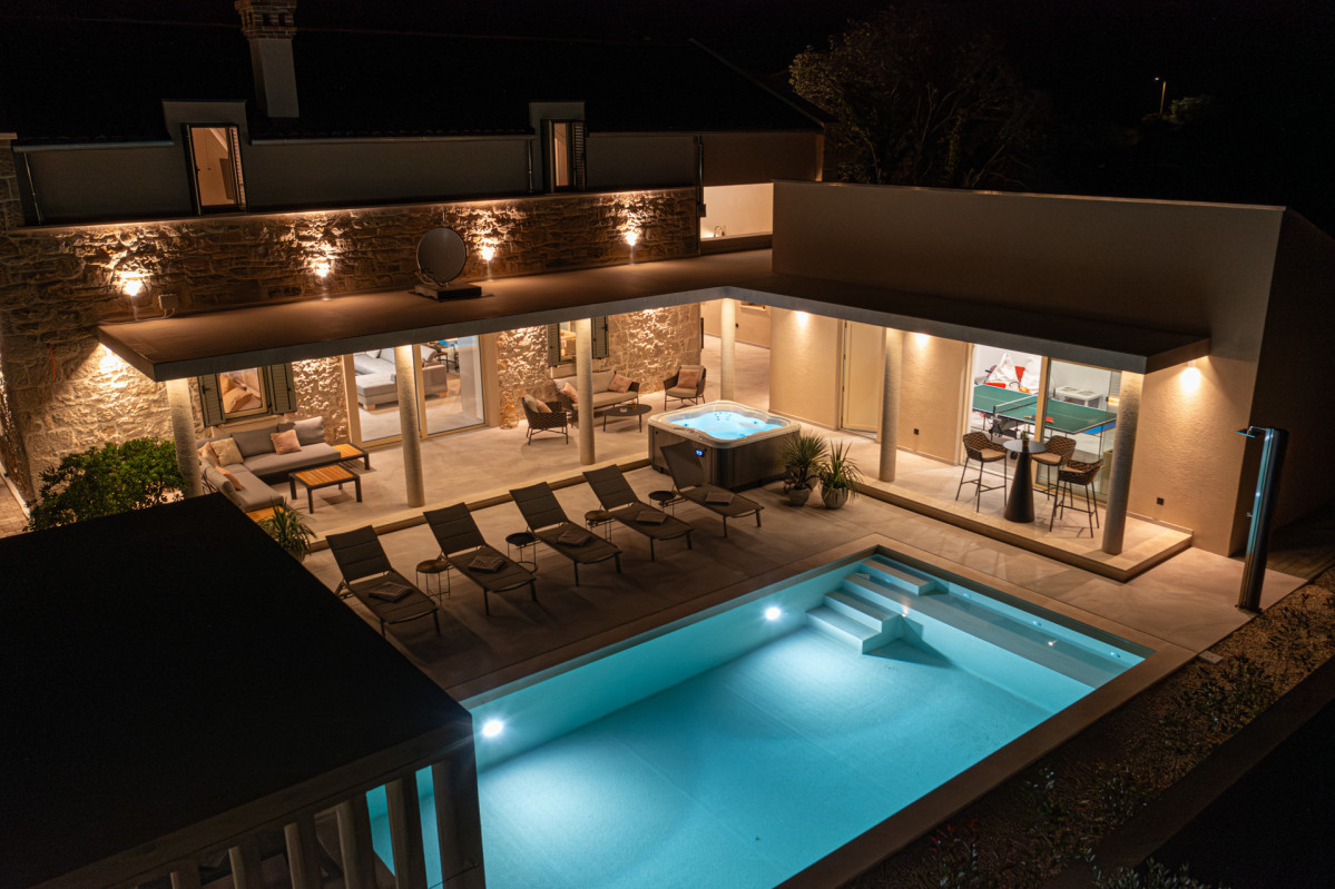 Luxury evening by the heated pool and elegant outdoor living spaces.