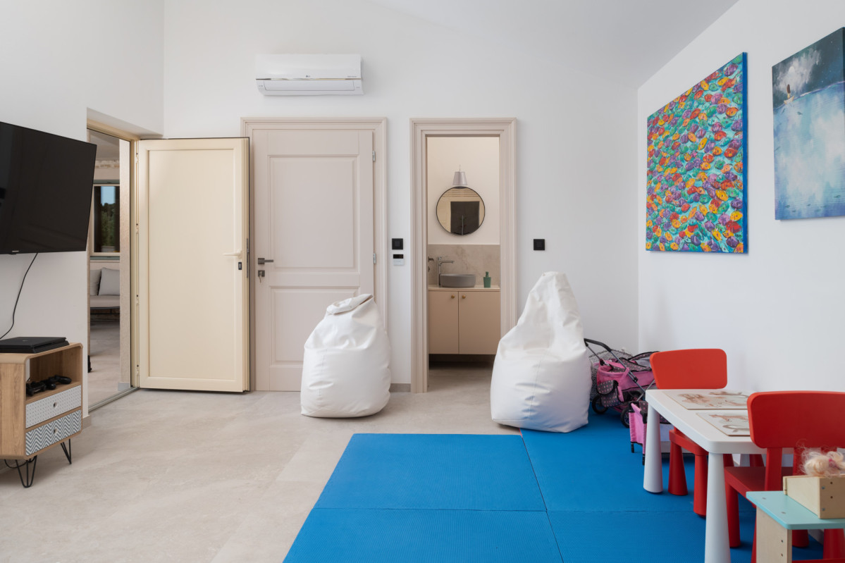 Modern playroom and family room with soft mats, bean bags, and wall art