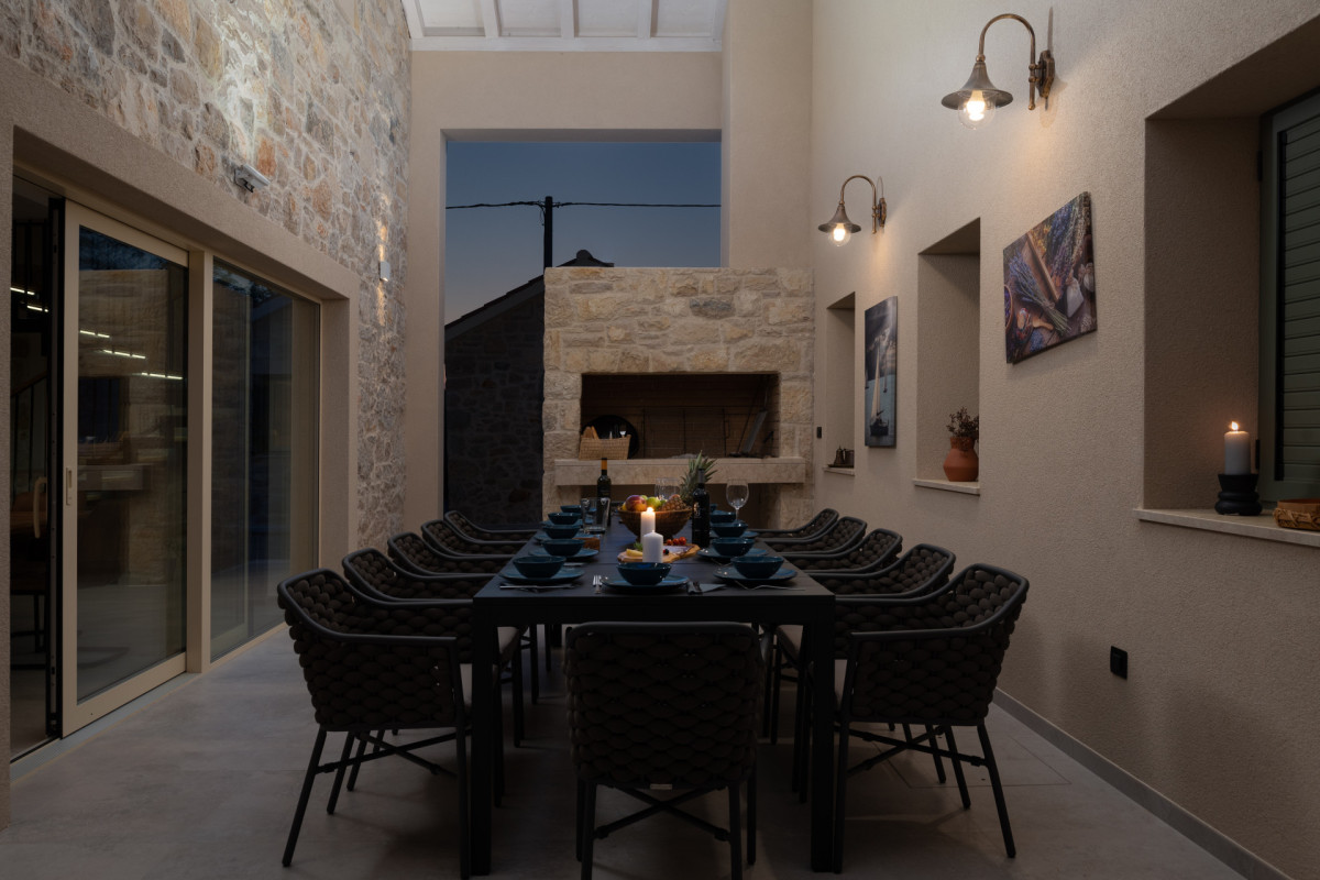 Sophisticated dining area at Villa Utopia with rustic charm and ambient lighting.