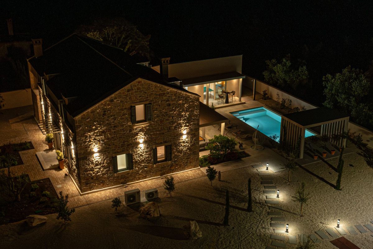 Villa Utopia an architectural stone residence with a charming modern courtyard, private pool, and scenic surroundings.